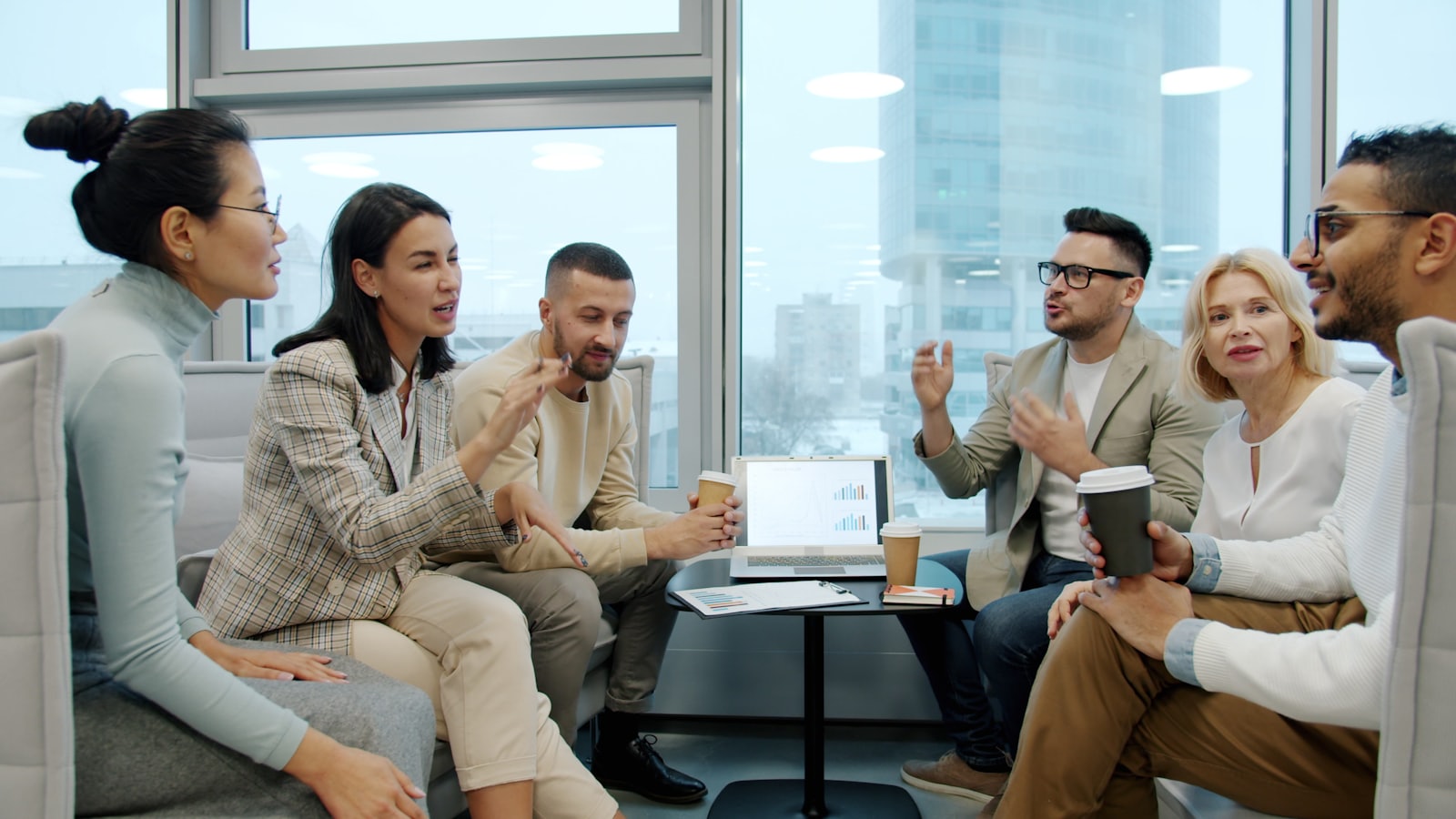 A diverse team of professionals — men and women of different backgrounds — collaborating in a bright office